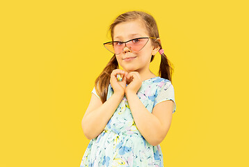 Image showing Beautiful emotional little girl isolated on yellow background