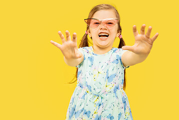 Image showing Beautiful emotional little girl isolated on yellow background