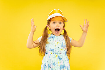 Image showing Beautiful emotional little girl isolated on yellow background