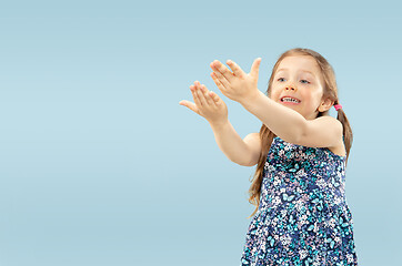 Image showing Beautiful emotional little girls isolated on blue background