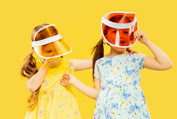 Image showing Beautiful emotional little girls isolated on yellow background