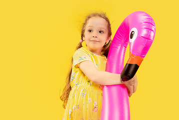 Image showing Beautiful emotional little girl isolated on yellow background