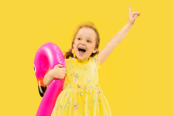 Image showing Beautiful emotional little girl isolated on yellow background