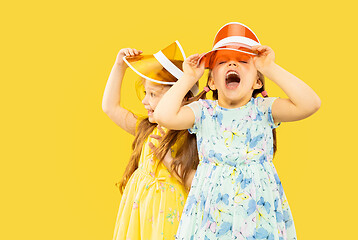 Image showing Beautiful emotional little girls isolated on yellow background