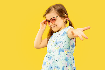 Image showing Beautiful emotional little girl isolated on yellow background