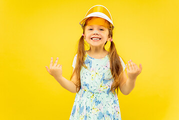 Image showing Beautiful emotional little girl isolated on yellow background