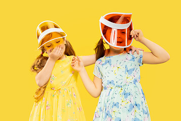 Image showing Beautiful emotional little girls isolated on yellow background