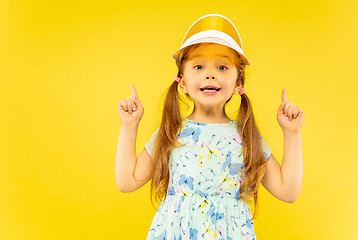 Image showing Beautiful emotional little girl isolated on yellow background