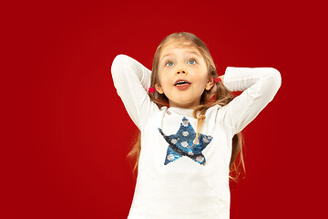 Image showing Beautiful emotional little girl isolated on red background