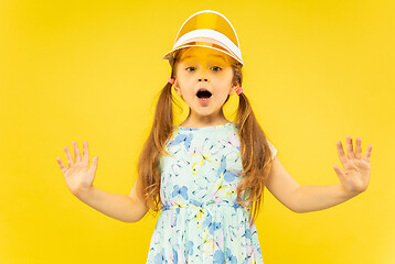 Image showing Beautiful emotional little girl isolated on yellow background