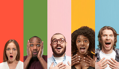 Image showing Young attractive people looking astonished on multicolored background