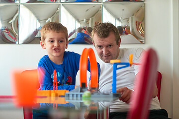 Image showing Father and children playing car toy game