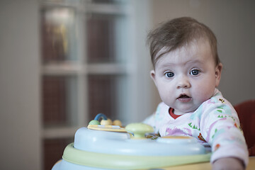 Image showing baby learning to walk in walker