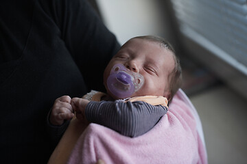 Image showing grandmother holding newborn baby at home