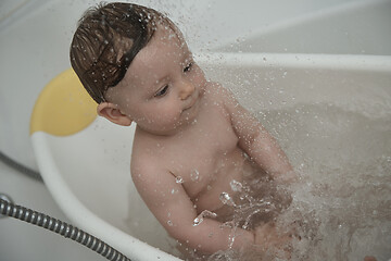 Image showing cute little baby girl taking a bath