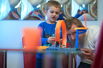 Image showing Father and children playing car toy game