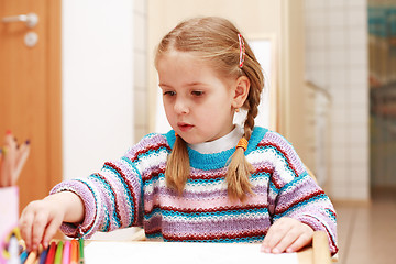 Image showing Cute little girl painting