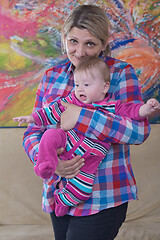 Image showing grandmother holding newborn baby at home