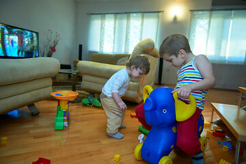 Image showing Little child playing with sister at home