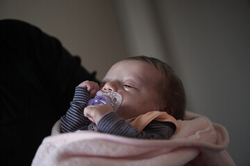 Image showing grandmother holding newborn baby at home