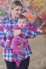 Image showing grandmother holding newborn baby at home