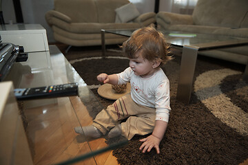 Image showing Adorable cute beautiful little baby girl playing with toys at home