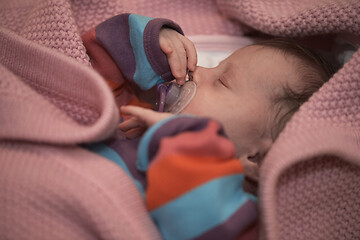 Image showing One month newborn baby sleeping in bed