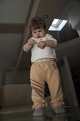 Image showing Adorable cute beautiful little baby girl playing with toys at home