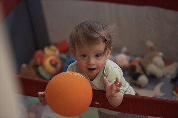 Image showing cute little baby playing in mobile bed