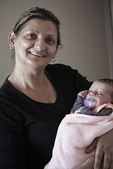 Image showing grandmother holding newborn baby at home