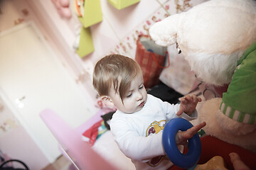 Image showing cute little one year old baby and making first steps