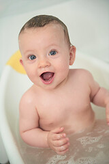 Image showing cute little baby girl taking a bath