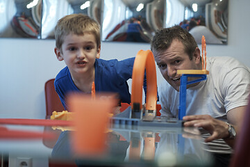 Image showing Father and children playing car toy game