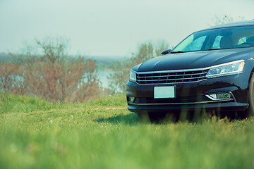 Image showing View of modern black car on the river\'s side