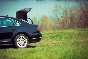 Image showing View of modern black car on the river\'s side