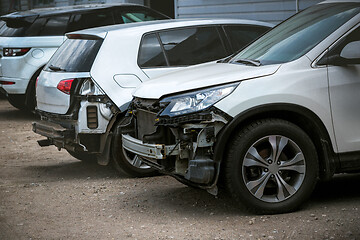 Image showing Broken and crashed modern cars after an accident on street