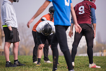 Image showing american football players stretching and warming up