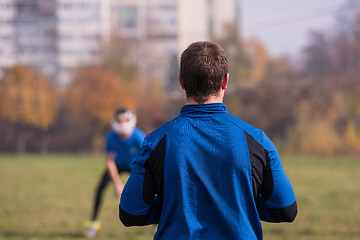 Image showing american football team with coach in action