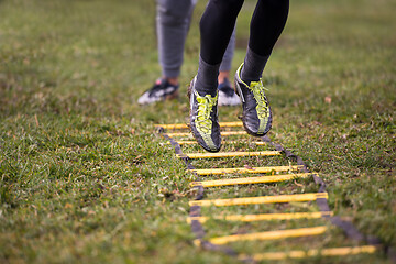 Image showing american football player exercises on ladder drills