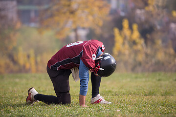 Image showing american football player resting after hard training