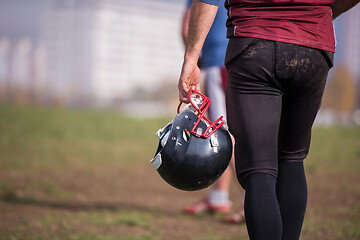 Image showing American football player holding helmet
