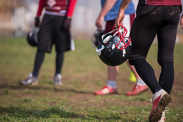 Image showing American football player holding helmet