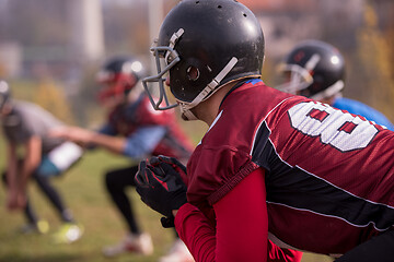 Image showing american football players stretching and warming up