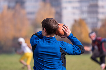 Image showing american football team with coach in action