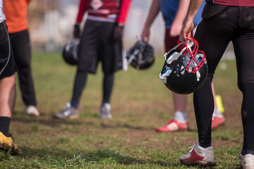 Image showing American football player holding helmet