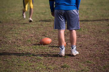 Image showing american football team with coach in action