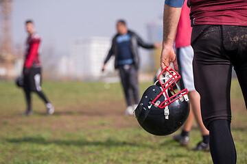 Image showing American football player holding helmet