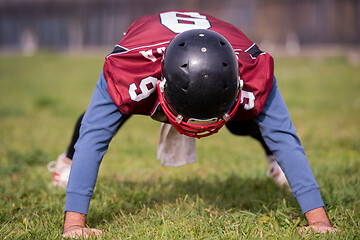 Image showing american football player doing push ups