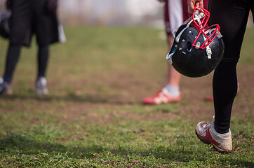 Image showing American football player holding helmet