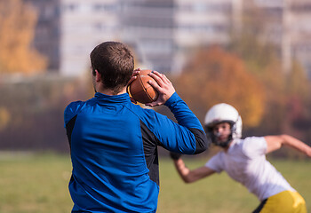 Image showing american football team with coach in action